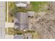 Aerial view of a backyard featuring a patio, deck, and mature trees at 10937 Sawgrass Dr, Fishers, IN 46037