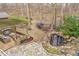 Aerial view of a backyard featuring a covered patio with seating, a fire pit, and a small pond at 10937 Sawgrass Dr, Fishers, IN 46037