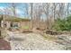 Spacious backyard with stone patio, outdoor seating under a pergola, a pond, and lush greenery at 10937 Sawgrass Dr, Fishers, IN 46037