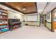 Basement media room featuring projector, screen, and wood trim, along with a built-in bookcase and adjacent storage area at 10937 Sawgrass Dr, Fishers, IN 46037