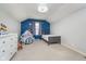 Well-lit bedroom with a celestial mural, a bed, and a play tent for children at 10937 Sawgrass Dr, Fishers, IN 46037