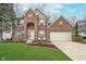 Charming two-story brick home featuring a well-manicured lawn and attached two car garage at 10937 Sawgrass Dr, Fishers, IN 46037