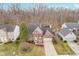 Aerial view of a charming two-story brick home with an attached two-car garage at 10937 Sawgrass Dr, Fishers, IN 46037