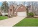 Traditional brick home with a two-car garage, inviting curb appeal, and mature trees at 10937 Sawgrass Dr, Fishers, IN 46037