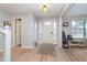 Bright foyer featuring wood floors, a white front door, and neutral wall paint at 10937 Sawgrass Dr, Fishers, IN 46037