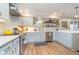 Bright open kitchen featuring stainless steel appliances, gray cabinets, a subway tile backsplash, and an eat-in breakfast bar at 10937 Sawgrass Dr, Fishers, IN 46037