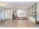 Bright living room with hardwood floors, a large window, and built in shelving at 10937 Sawgrass Dr, Fishers, IN 46037