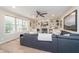 Cozy living room features a stone fireplace, a ceiling fan, built-in shelving, and large windows for natural light at 10937 Sawgrass Dr, Fishers, IN 46037