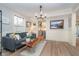 Bright living room with a wood coffee table, hardwood floors, and neutral walls at 10937 Sawgrass Dr, Fishers, IN 46037