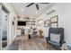 Bright home office featuring a ceiling fan, shiplap walls, built in shelving, and a wooden desk at 10937 Sawgrass Dr, Fishers, IN 46037