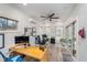 Bright home office featuring a ceiling fan, shiplap walls, a wooden desk, and access to an outdoor patio at 10937 Sawgrass Dr, Fishers, IN 46037