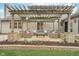 Backyard patio featuring outdoor seating beneath a pergola, offering an inviting space for relaxation and entertaining at 10937 Sawgrass Dr, Fishers, IN 46037
