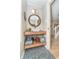 Stylish powder room featuring mosaic floors, a vessel sink, a wooden framed mirror, and extra storage space at 10937 Sawgrass Dr, Fishers, IN 46037
