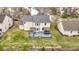 Aerial view of the home showcasing the backyard deck with hot tub and outdoor dining area at 11046 Timberview Dr, Fishers, IN 46037