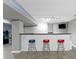 Basement bar area features stone accents, barstool seating, and game room area at 11046 Timberview Dr, Fishers, IN 46037