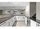 Finished basement with a bar area featuring granite counters and white cabinetry at 11046 Timberview Dr, Fishers, IN 46037