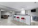 Finished basement bar with a beverage fridge, stone accents, and leather couch at 11046 Timberview Dr, Fishers, IN 46037