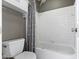 Updated full bathroom with white tiled shower and tub and white tile walls and gray accent walls at 11046 Timberview Dr, Fishers, IN 46037
