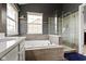 Luxurious bathroom boasts a soaking tub, glass-enclosed shower, and a sleek vanity at 11046 Timberview Dr, Fishers, IN 46037