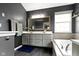Well-lit bathroom featuring a double vanity, large mirror, soaking tub, and modern fixtures at 11046 Timberview Dr, Fishers, IN 46037
