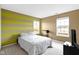 Bedroom with striped accent wall and large windows allowing natural light to enter at 11046 Timberview Dr, Fishers, IN 46037