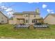 This is a view of a tan house with a deck and outdoor seating in the backyard at 11046 Timberview Dr, Fishers, IN 46037