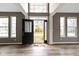Welcoming foyer featuring gleaming hardwood floors, gray walls, and a striking front door with glass sidelights at 11046 Timberview Dr, Fishers, IN 46037