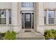 Elegant front door entrance with decorative sidelights and transom window, nestled in an inviting brick facade at 11046 Timberview Dr, Fishers, IN 46037