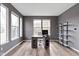 Bright home office with a modern desk, shelving unit, and ample natural light from large windows at 11046 Timberview Dr, Fishers, IN 46037
