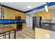 Well-equipped kitchen featuring wooden cabinets, stainless steel appliances, and a refrigerator at 11046 Timberview Dr, Fishers, IN 46037