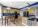 Cozy kitchen featuring a kitchen island with stools, hardwood floors, and stainless steel appliances at 11046 Timberview Dr, Fishers, IN 46037