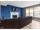 Inviting living room with a white fireplace, a large TV, and natural light from three windows at 11046 Timberview Dr, Fishers, IN 46037