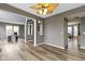 Open-concept living room featuring natural wood floors, modern lighting, and seamless transitions to other rooms at 11046 Timberview Dr, Fishers, IN 46037