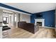 Spacious living room featuring a fireplace, hardwood floors, and a leather couch at 11046 Timberview Dr, Fishers, IN 46037