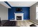 Cozy living room featuring a fireplace with a television, hardwood floors, and couch at 11046 Timberview Dr, Fishers, IN 46037
