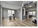 Spacious living room featuring hardwood floors, neutral color scheme, and large windows that flood the space with light at 11046 Timberview Dr, Fishers, IN 46037