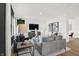 Modern living room featuring a grey sofa, lamps, and a large tv at 1248 Taggart Way, Greenwood, IN 46143