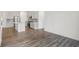 Open-concept living space flowing into a modern kitchen with stainless steel appliances and an island at 1255 Thornwood Dr, Greenwood, IN 46143