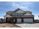 Two-story home featuring a two-car garage, brick accents, and gray siding under a blue sky at 1260 Thornwood Dr, Greenwood, IN 46143