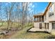 Backyard featuring a stone patio and a wooded backdrop, perfect for outdoor relaxation at 12618 E 86Th St, Indianapolis, IN 46236