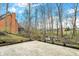 Backyard featuring a stone patio with a backdrop of trees, creating a serene outdoor space at 12618 E 86Th St, Indianapolis, IN 46236