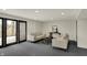 Comfortable finished basement with couches, a coffee table, and sliding glass doors to the outside at 12618 E 86Th St, Indianapolis, IN 46236