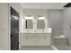 Modern bathroom features a double vanity, elegant mirrors, and a frameless shower with built-in bench at 12618 E 86Th St, Indianapolis, IN 46236
