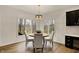 Cozy dining area featuring a wooden table, plush chairs, and large windows with lush greenery at 12618 E 86Th St, Indianapolis, IN 46236
