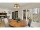 Bright and airy dining area with a round table and scenic views through large windows at 12618 E 86Th St, Indianapolis, IN 46236