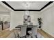 Chic dining area with modern chandelier, decorative art, and seating for four at 12618 E 86Th St, Indianapolis, IN 46236