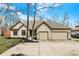 Charming brick home featuring an attached two car garage and a spacious driveway at 12618 E 86Th St, Indianapolis, IN 46236