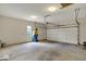 Spacious garage with a white door, cement floors, and a window for natural light at 12618 E 86Th St, Indianapolis, IN 46236