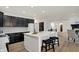 Bright kitchen showcases a center island, black cabinets, and seamlessly connects to the dining and living areas at 12618 E 86Th St, Indianapolis, IN 46236