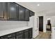Chic kitchen featuring black cabinets, stainless steel appliances, and white quartz countertops at 12618 E 86Th St, Indianapolis, IN 46236